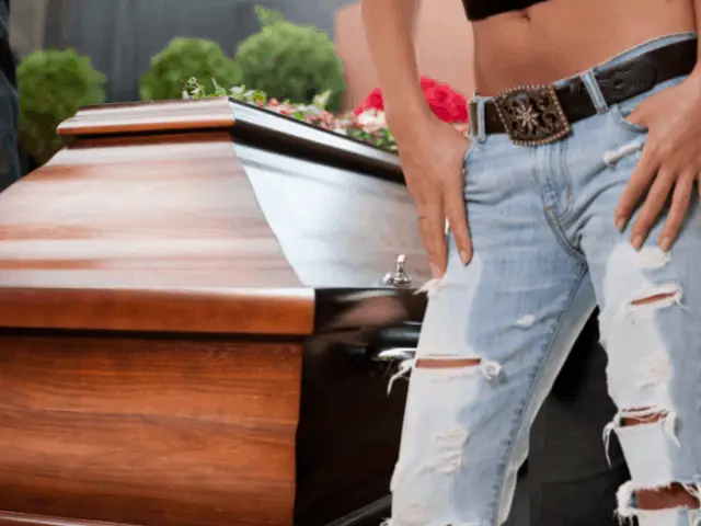 wearing ripped jeans next to casket