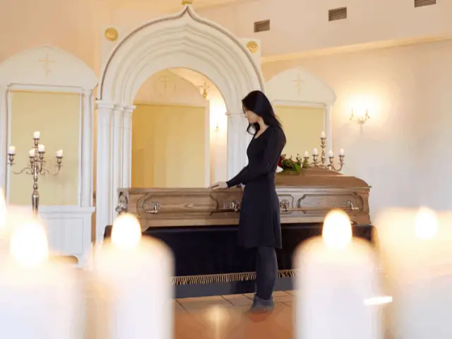 Woman next to casket
